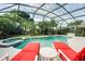 Screened pool featuring a spa and lounge chairs perfect for relaxing in a private setting at 615 Copeland Dr, Haines City, FL 33844