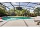 Screened in pool with a spa and a beautiful view of the well maintained backyard landscaping at 615 Copeland Dr, Haines City, FL 33844