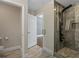 A modern bathroom with a large glass shower and stone tile at 6873 Slaven Dr, Orlando, FL 32819