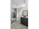Beautiful bathroom with a modern glass shower, large vanity, and stylish fixtures at 6873 Slaven Dr, Orlando, FL 32819