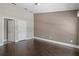 Neutral bedroom with dark wood floors and two entryways, one with door at 6873 Slaven Dr, Orlando, FL 32819