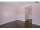 Bedroom featuring hardwood flooring, soft pink walls, and natural light at 6873 Slaven Dr, Orlando, FL 32819