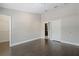 Neutral bedroom with dark wood flooring and entrance to a closet and bathroom at 6873 Slaven Dr, Orlando, FL 32819