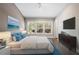 Bright bedroom featuring a large bed, dresser, and large bright windows at 6873 Slaven Dr, Orlando, FL 32819