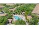 A high angle shows the amazing community pool with plenty of seating and lush trees at 6873 Slaven Dr, Orlando, FL 32819