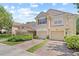 Attractive townhomes with private garages, landscaped yards, and tile roofs for lasting appeal at 6873 Slaven Dr, Orlando, FL 32819