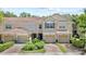 Charming townhome featuring a well-manicured lawn, two-car garage, and elegant front door at 6873 Slaven Dr, Orlando, FL 32819