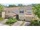 Beautiful townhome boasts a two-car garage, perfectly maintained landscaping, and paver driveway at 6873 Slaven Dr, Orlando, FL 32819
