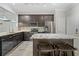 Bright kitchen featuring a granite island with seating, stainless appliances, and modern cabinetry at 6873 Slaven Dr, Orlando, FL 32819