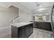 Modern kitchen features an island with granite countertops, stainless steel appliances, and wood flooring at 6873 Slaven Dr, Orlando, FL 32819