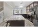 Granite kitchen island with stylish pendant lighting and stainless steel appliances at 6873 Slaven Dr, Orlando, FL 32819