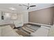 Spacious living room with hardwood floors and easy access to the adjacent kitchen at 6873 Slaven Dr, Orlando, FL 32819