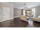 Living room featuring hardwood floors, modern lighting, and access to the screened porch at 6873 Slaven Dr, Orlando, FL 32819