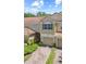 Charming two-story townhouse with a tile roof, single car garage, and brick driveway at 6873 Slaven Dr, Orlando, FL 32819