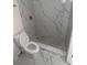 Bathroom featuring marble tile flooring and a shower with marble walls at 7341 Daniel Webster Dr # 4, Winter Park, FL 32792