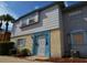 Two-story townhouse featuring light gray siding and a brick base, complemented by a blue trim at 7341 Daniel Webster Dr # 4, Winter Park, FL 32792