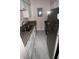 A galley kitchen features stainless steel appliances, granite countertops, and marble tile flooring at 7341 Daniel Webster Dr # 4, Winter Park, FL 32792