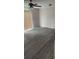 An empty living room is awash in natural light and boasts luxury vinyl plank flooring at 7341 Daniel Webster Dr # 4, Winter Park, FL 32792