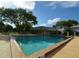A pool is surrounded by a deck with a community clubhouse nearby at 7341 Daniel Webster Dr # 4, Winter Park, FL 32792