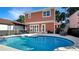 Private backyard oasis featuring a sparkling pool, patio and lush greenery at 7422 Sparkling Ct, Reunion, FL 34747