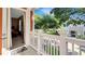 Open-air balcony with a railing, a view of a green lawn, and an entrance to a bedroom at 7422 Sparkling Ct, Reunion, FL 34747
