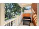 Relaxing balcony with outdoor seating and a scenic view of the neighborhood trees at 7422 Sparkling Ct, Reunion, FL 34747