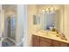 Spacious bathroom features a vanity with cabinets, a mirror, and a shower at 7422 Sparkling Ct, Reunion, FL 34747