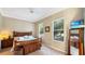 Comfortable bedroom with a wooden bed frame, two windows, neutral walls and a ceiling fan at 7422 Sparkling Ct, Reunion, FL 34747