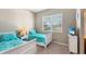 Bright bedroom features twin beds, a window with blinds, and a side table at 7422 Sparkling Ct, Reunion, FL 34747
