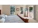 Bedroom features a wooden bed frame and access to an outdoor balcony with natural lighting at 7422 Sparkling Ct, Reunion, FL 34747