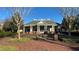 Welcoming community clubhouse with classic architectural design, surrounded by well-maintained landscaping at 7422 Sparkling Ct, Reunion, FL 34747