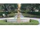 Elegant fountain feature in landscaped common area of a Primary-planned community at 7422 Sparkling Ct, Reunion, FL 34747