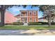 Charming two-story home with a inviting front porch and meticulously landscaped garden at 7422 Sparkling Ct, Reunion, FL 34747