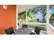 Cozy front porch features comfortable wicker furniture and views of the charming neighborhood at 7422 Sparkling Ct, Reunion, FL 34747