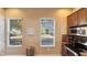 Modern kitchen with stainless steel appliances, ample cabinet space, and a view to the outdoors at 7422 Sparkling Ct, Reunion, FL 34747