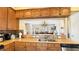 Stylish kitchen with granite countertops, wood cabinets, and an open view to the dining area at 7422 Sparkling Ct, Reunion, FL 34747