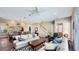 Spacious living room with a staircase, neutral decor, tile flooring, and comfortable seating at 7422 Sparkling Ct, Reunion, FL 34747