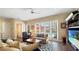 Bright living room featuring comfortable seating, large windows, and a view of the pool area at 7422 Sparkling Ct, Reunion, FL 34747