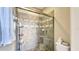 A tiled shower enclosure with a glass door in a bathroom setting with neutral wall tones at 7422 Sparkling Ct, Reunion, FL 34747
