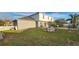 View of the backyard with a grass lawn and a patio at 773 Leopard Ct, Kissimmee, FL 34759