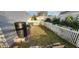A view of the backyard featuring a white fence and a rainwater barrel at 773 Leopard Ct, Kissimmee, FL 34759