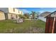 Spacious backyard featuring a green lawn, landscaping, and a white fence at 773 Leopard Ct, Kissimmee, FL 34759