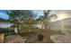 Private backyard has a lush lawn, mature trees, white fence, and a patio perfect for relaxation and outdoor entertainment at 773 Leopard Ct, Kissimmee, FL 34759