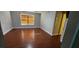 Clean bedroom featuring wood flooring, a window with blinds, and overhead ceiling fan for added comfort and style at 773 Leopard Ct, Kissimmee, FL 34759
