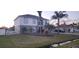Two-story home showcasing manicured lawn, landscaped beds and an oversized driveway leading to an attached garage at 773 Leopard Ct, Kissimmee, FL 34759