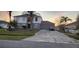 Charming two-story home with a well-maintained yard and mature palm trees, featuring a spacious driveway and attached garage at 773 Leopard Ct, Kissimmee, FL 34759