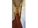 Hallway with hardwood floors leading to an open door at 773 Leopard Ct, Kissimmee, FL 34759