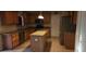 Well-lit kitchen with stainless steel appliances, wood cabinets, granite countertops, and a functional center island at 773 Leopard Ct, Kissimmee, FL 34759