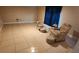 A roomy living room with tiled flooring, neutral walls, and a relaxing seating area for comfortable living at 773 Leopard Ct, Kissimmee, FL 34759