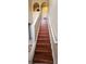 Staircase with hardwood steps and white railings, connecting the home's floors, providing an elegant transition at 773 Leopard Ct, Kissimmee, FL 34759